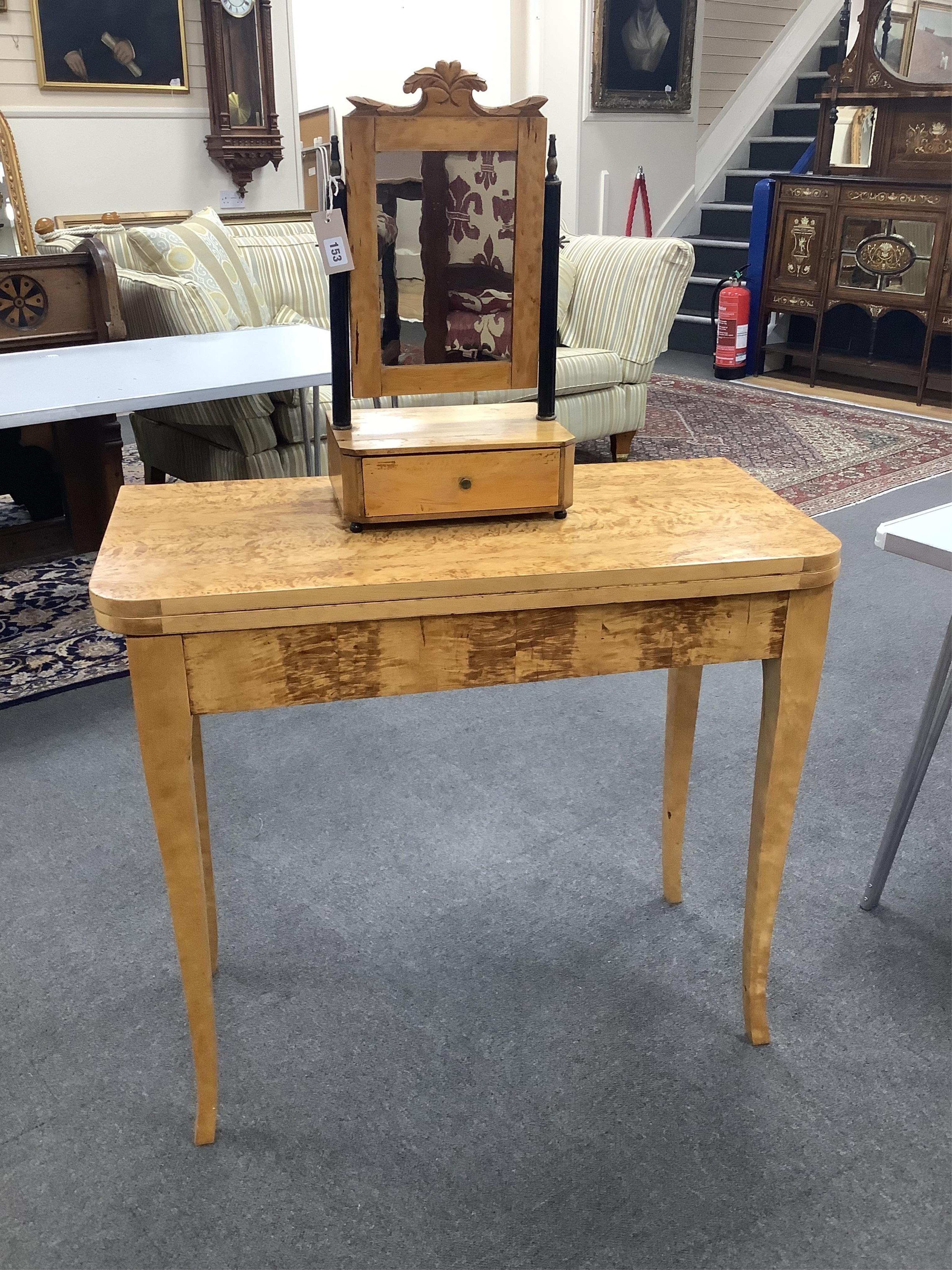 A Biedermeier style birch folding tea table, width 89cm, depth 43cm, height 79cm, together with a similar toilet mirror. Condition - fair